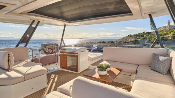 Among catamaran rental options in Athens Majesty of Greece upper deck seating area offers relaxing space with sea view.