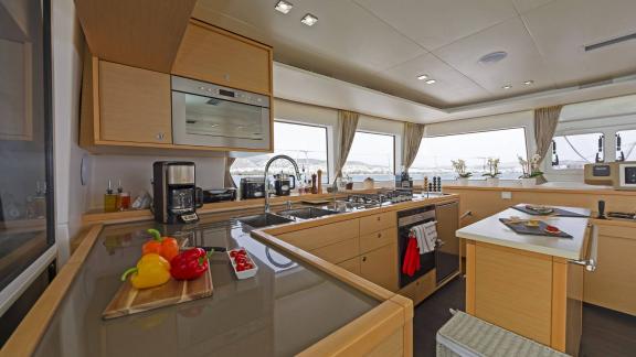 Well-equipped kitchen on the Lagoon 560 S2 Meliti, surrounded by windows with a view of the sea