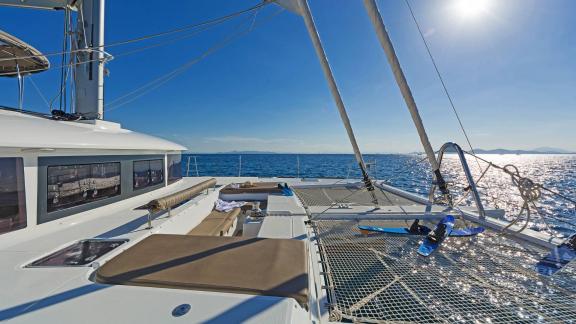 Sun deck of the Lagoon 560 S2 Meliti with comfortable lounging areas and a view of the vast sea