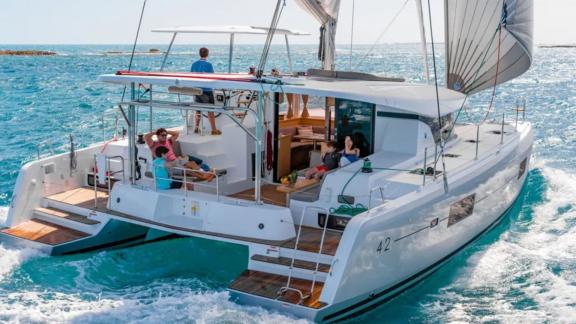 Guests enjoy the sun and sea on the stylish Lagoon 42 catamaran in Fethiye, Turkey.