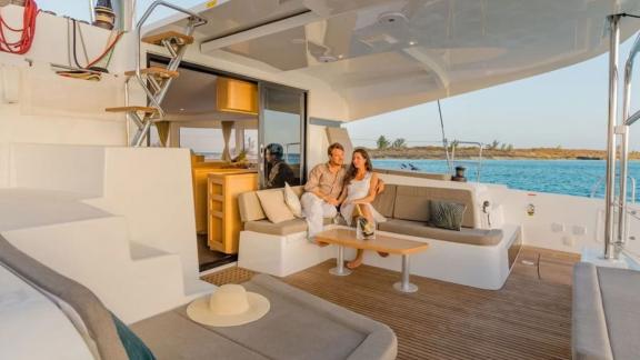 A couple enjoys the sunset on the stylish deck of the Lagoon 42 catamaran in Fethiye, Turkey.