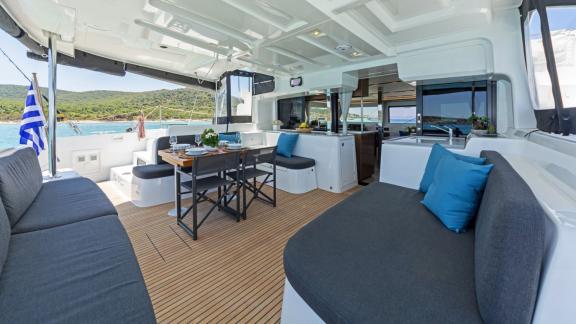 Open-air comfort with cushions, wood flooring, and a cozy dining table.
