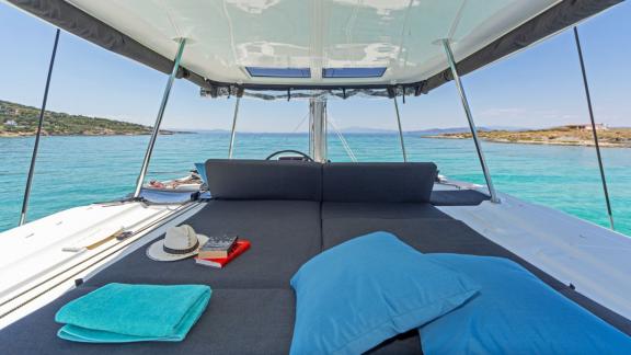Shaded upper deck with a book and sea view offers perfect calm.