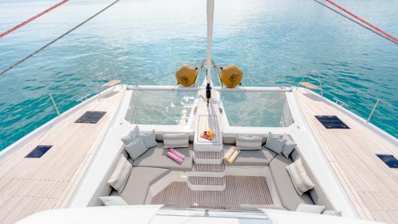 Comfortable seating area on the yacht's foredeck overlooking calm waters