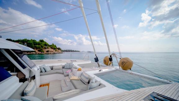 Relaxation area on the yacht's foredeck overlooking the coast and sea