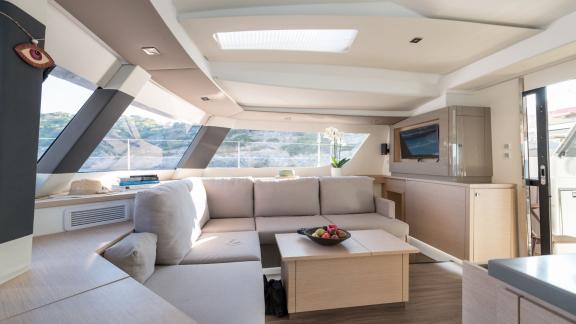 Cozy salon on the catamaran Pi 2 in Athens with a large seating area and natural light.