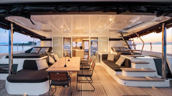 Among catamaran rental options Princess Karla aft deck with dining table and seating area is seen as a relaxing space in