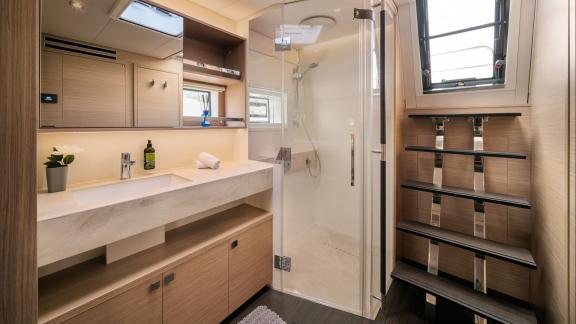 Among catamaran rental options Princess Karla bathroom with shower cabin and sink offers a spacious onboard experience.