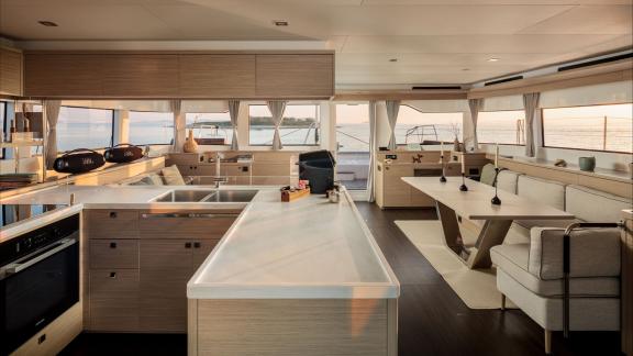 Among catamaran rental options Princess Karla features a spacious kitchen and cozy interior seating area for onboard com