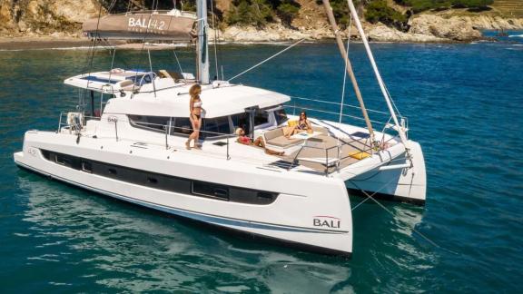 Guests enjoy the sun and sea on the deck of the catamaran Bali 4.2 off the coast of Fethiye, Turkey.