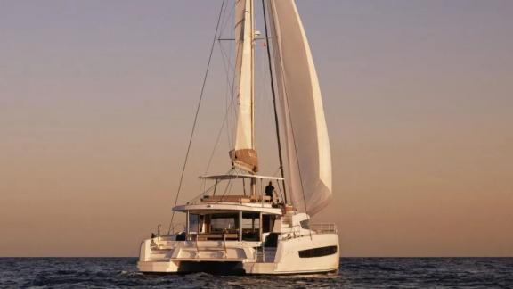 The Sahana catamaran offers a peaceful sail on the open sea at sunset.