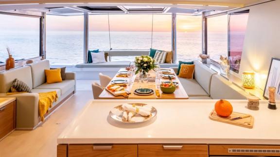 Spacious dining area on the Sahana catamaran overlooking the peaceful sunset.