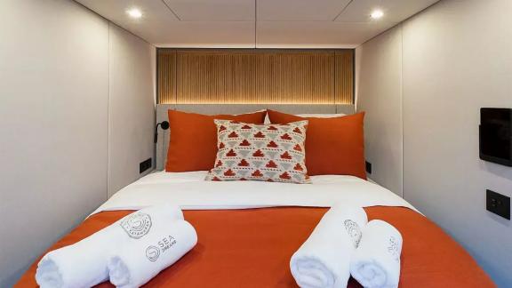 Guest cabin of the Sunreef 60 Sea Dreams catamaran in Split Marina, Croatia, offering a comfortable stay at sea.