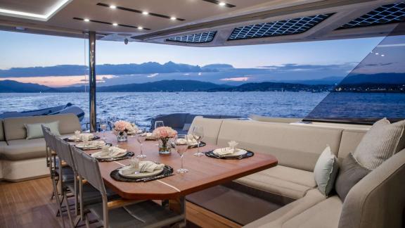 Fountaine Pajot 80 Serenissima III features spacious seating and an outdoor dining area on the aft deck overlooking the