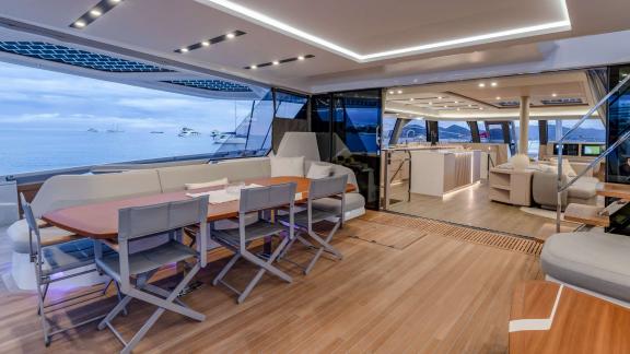 Fountaine Pajot 80 Serenissima III features a spacious dining table, lounge seating and seamless access to the saloon.