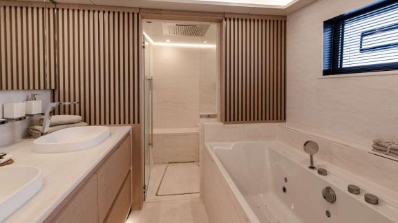 Serenissima III in Athens features a modern bathroom with bathtub and elegant amenities for guest comfort.