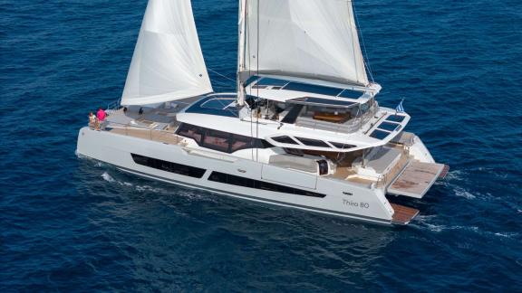Fountaine Pajot 80 Serenissima III is captured from above while sailing with full sails across the waters of Athens.