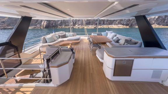 Fountaine Pajot 80 Serenissima III features spacious lounge seating and an outdoor dining table on the upper deck.