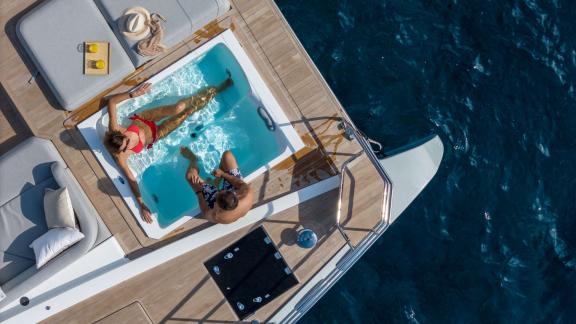 Fountaine Pajot 80 Serenissima III features a sea view jacuzzi and private relaxation space for luxury yacht holidays.
