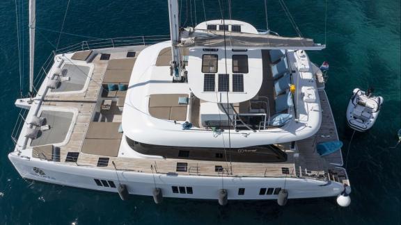 Relax and soak up the sun on Sinata's spacious Sunreef 60 flybridge and lounging areas.