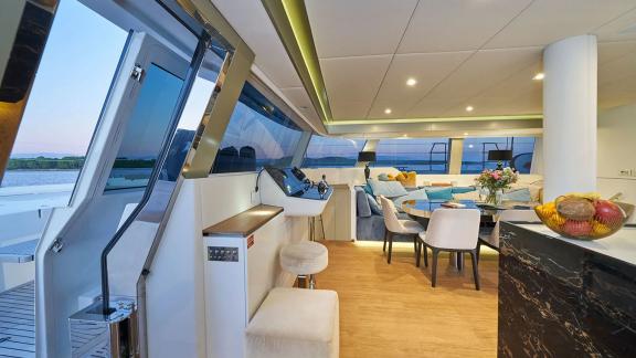 Sunreef 60 catamaran Sinata offers a sleek and cozy salon bathed in light through full-height windows.