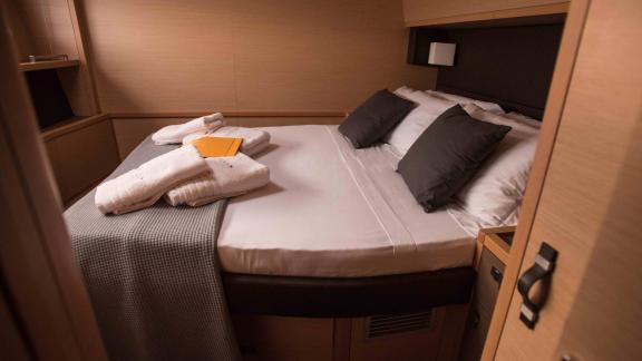 Cabin on Soleanis II with prepared double bed and fresh towels, perfect for relaxation