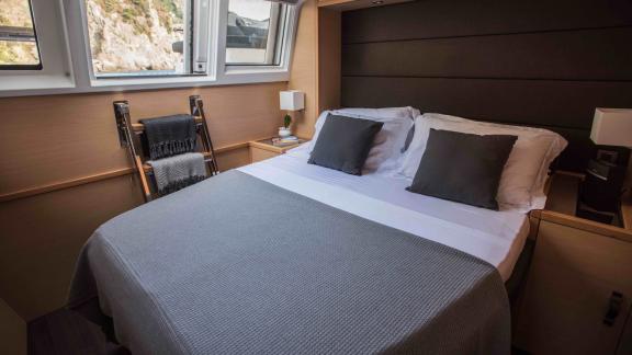 Comfortable cabin on Soleanis II with double bed, large windows, and stylish decor