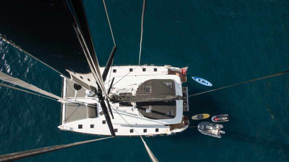 Aerial view of the catamaran Soleanis II with several tenders on calm water