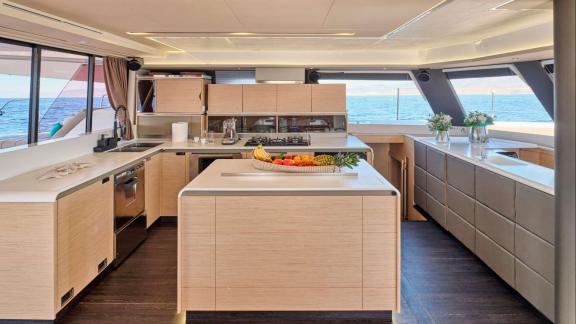 The spacious and bright kitchen of the Sunmoon yacht turns cooking into a pleasure with open sea views.