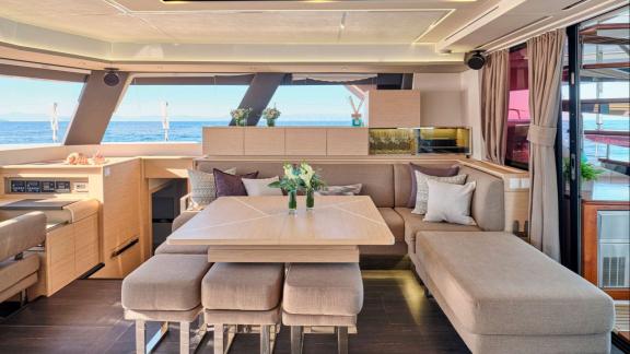 The modern interior of the Sunmoon yacht offers a comfortable dining experience with a stunning sea view.
