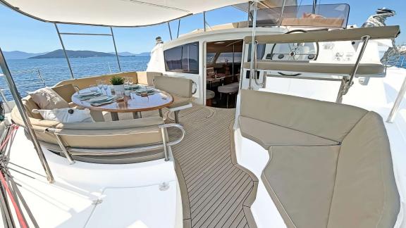 The inviting dining area on the aft deck of the catamaran Zorba with stunning sea views.