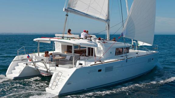 The Zuzo 2 sails smoothly on calm seas with a relaxed crew on board.