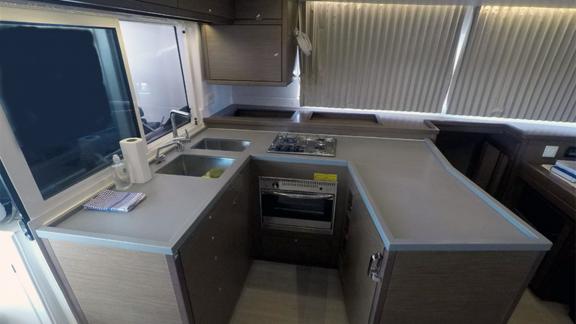 Functional kitchen with stove, sink, and ample counter space for onboard comfort.