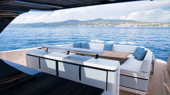 Among Saint Tropez yacht charter options Pegase motor yacht shows aft deck with dining table and lounge seating.