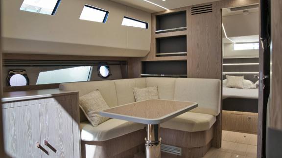 Among Saint Tropez yacht charter options Pegase motor yacht shows interior with corner sofa and table.