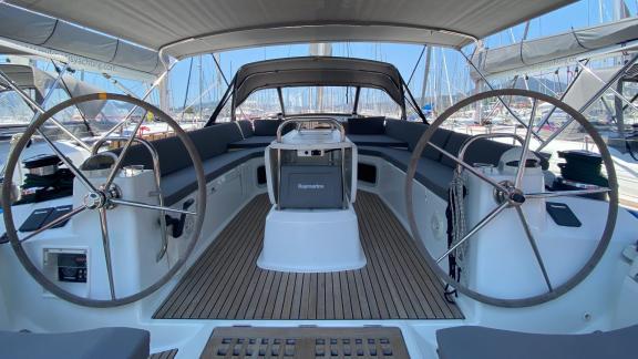 The helm area of the Mocha II sailing yacht features a spacious seating area and dual helm wheels.