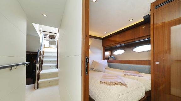 Bright and comfortable guest cabin with a double bed and direct access to the upper deck aboard the Motoryacht Agave in 