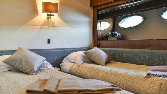 Comfortable cabin with two single beds and stylish decor aboard the Motoryacht Agave in Split.