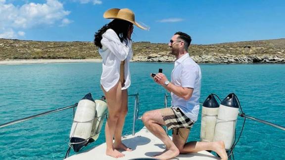 A romantic proposal moment unfolds on the bow of Blondie yacht