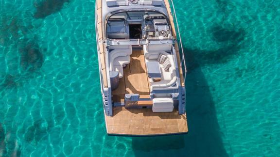 The spacious aft deck of Este yacht is perfect for enjoying Mykonos' turquoise waters.