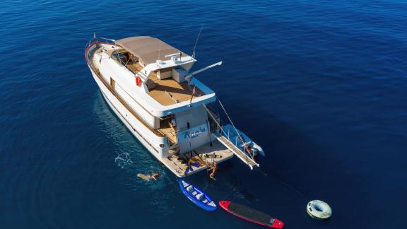 People enjoying water toys on the aft deck of motor yacht Custom Blanka.