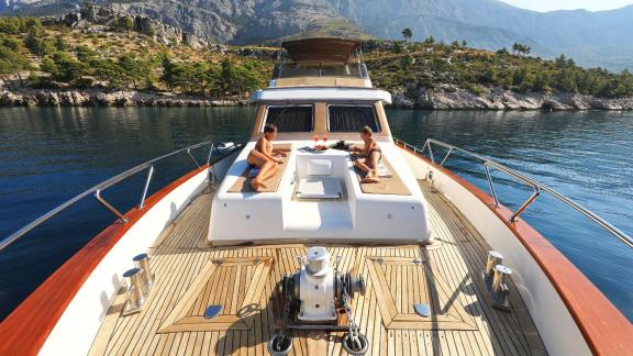 Two people enjoying the view on the foredeck of motor yacht Custom Blanka.