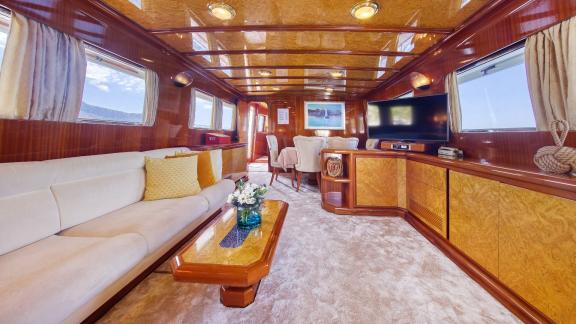 Luxurious interior salon of motor yacht Custom Blanka with a spacious seating area and a TV.