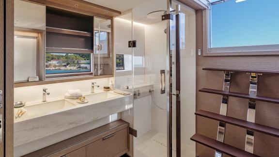 Elegant bathroom on the Catamaran Daiquiri featuring double sinks, a rain shower, and natural light from a panoramic win