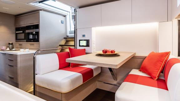 Stylish breakfast nook on the Catamaran Daiquiri with modern seating and direct access to the fully equipped kitchen.