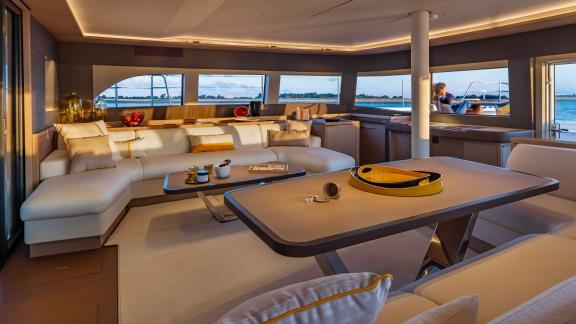 The salon of the Catamaran Daiquiri offers a cozy atmosphere at sunset, featuring spacious seating and stunning sea view