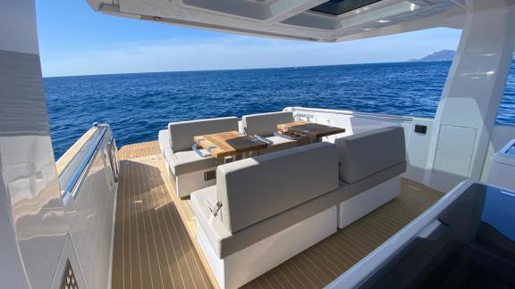 Among Nice day boat rental options, Coco is seen with an outdoor seating area overlooking the sea.