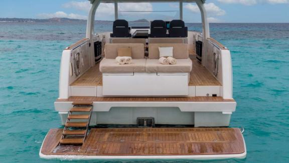 Among Nice private yacht charter options, Coco is seen with a sea level seating area on the aft deck.