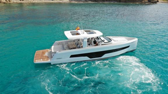 Among Nice private boat tour options, Coco is seen cruising through turquoise waters from above.