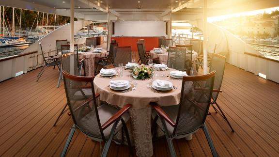 Stylishly set table for an outdoor dinner on the motor yacht Queen Eleganza in Croatia